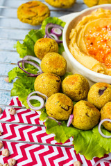 Baked chickpea falafel to eat with hummus, salad leaves and pita bread. Vegan healthy food.