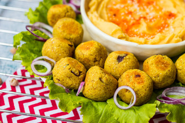 Baked chickpea falafel to eat with hummus, salad leaves and pita bread. Vegan healthy food.