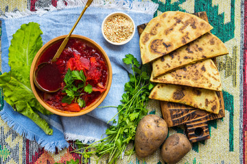 Red borsch - homemade Russian traditional vegetables soup with cabbage, sauerkraut, beetroot and parsley. Vegan healthy food. Ingredients.