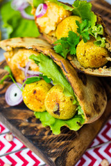 Baked chickpea falafel to eat with hummus, salad leaves and pita bread. Vegan healthy food.