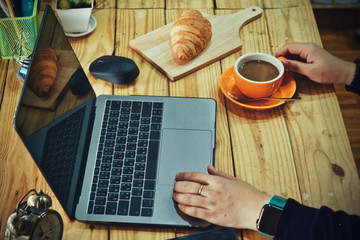 Coronavirus Business woman working from home wearing protective mask. Working from home . Cleaning her hands with sanitizer gel .