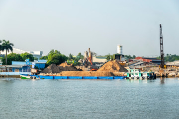Exploiting sands on the Mekong River. Boats carrying sand on the river in Vinh Long, Vietnam.