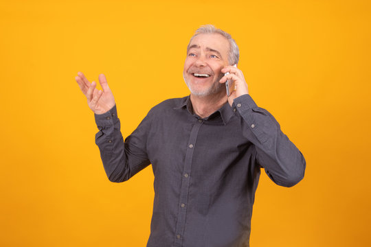 Adult Or Senior Man With Mobile Phone Isolated On Color Background