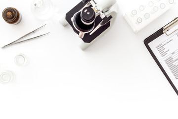 Clinical science research with microscope. Laboratory equipment on white background top view copy space