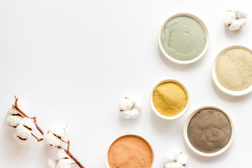 cosmetic clay - Yellow, red, white, blue and black - on white background top-down space for text