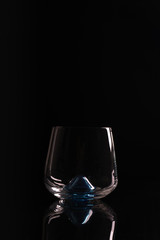 empty clean glass on black surface with reflection