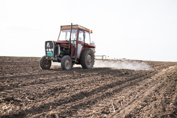 tractor sprays the field before germination.