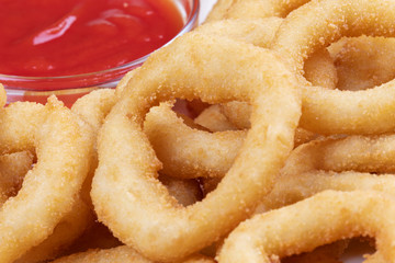 Delicious onion rings and ketchup on a plate
