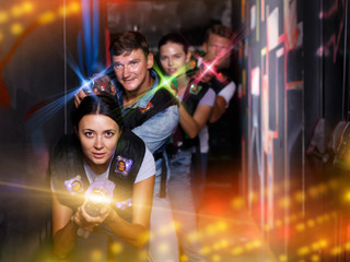 Group adult people playing laser tag  game