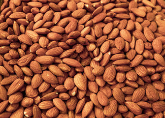 Background made of nuts. Peeled almond bones at the market. Healthy, wholesome food. Organic products. Source of vitamins and minerals. Grocery market in Georgia.