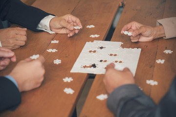 Implement improve puzzel solve connections together with synergy strategy team building organizing connection by trust communication. Hands of stakeholders business trust team holding jigsaw puzzle