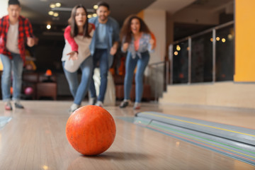 Friends playing bowling in club