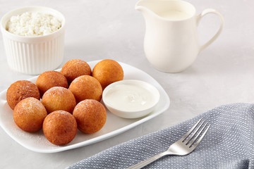 Beautiful breakfast. Cottage cheese donuts  balls  on a light background.