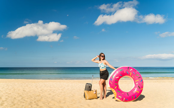 Tourists with Luggage and Beach hose on the beach pose for photos in good weather and clear skies during holiday at thailand in summer vacation in holiday and activity concept with copy space.