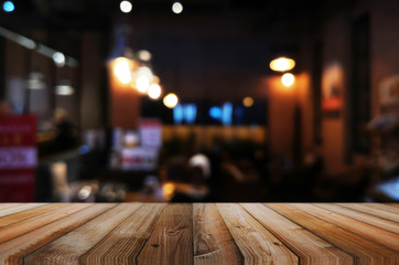 wooden table with abstract blurred background resturant lights used for display montage products mock up design.