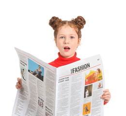 Surprised little girl with newspaper on white background