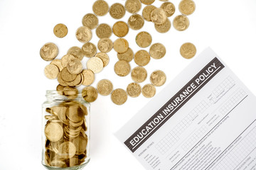 Fototapeta na wymiar Coins in jar with education insurance policy