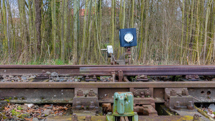 A close-up of a switch on an old, disused railway line in Germany in winter. The switch has a...