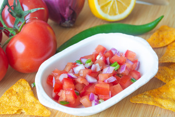 Mexican salsa pico de gallo with tomatoes, red onions, spicy green jalapeno pepper, lemon and nacho corn chips