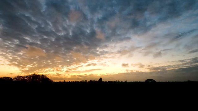 4K wide angle shot Time lapse video Scene of Colorful sunset with Moving clouds background in nature and travel concept