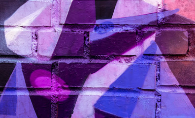 Beautiful bright colorful street art graffiti background. Abstract creative spray drawing fashion colors on the brick walls of the city. Urban Culture ,blue, purple , violet , neon texture