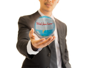 Businessman holding globe with medical mask on prevent spreading COVID-19 concept.