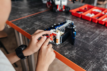Close up shot of a young boy concentrating repairing his electronic robot toys playing building creating invention electronics robotics technology scientific education hobby leisure lifestyle children