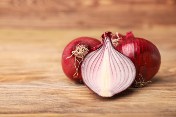 Fresh raw onion on wooden background
