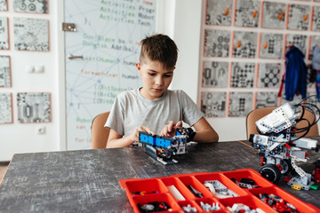 Child plays with a robotic toy assembled from the designer