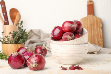 Bowls with fresh raw onion on table