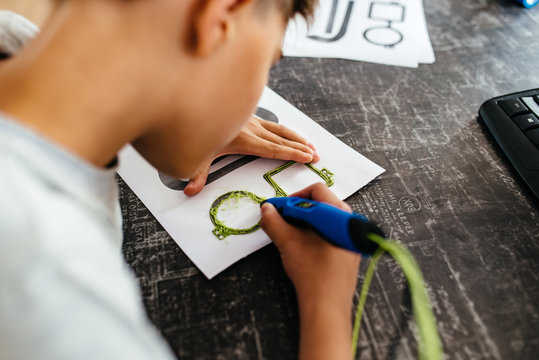 Child using 3D printing pen. Boy making new item. Creative, technology, leisure, education concept