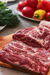 Several pieces of beef meat are lying on a board.