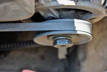 
old belt and pulley of a car generator. top view