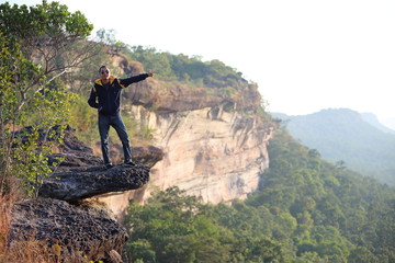 Man standing on the cliff at Pha Tam National Park, Ubon Ratchathani, Thailand