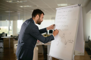 Young businessman working in office. Handsome man preparing for the meeting.