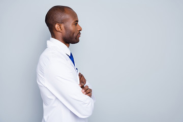 Profile photo of doctor dark skin guy virologist look side empty space corona virus seminar listen colleagues research arms crossed wear white lab coat tie isolated grey color background © deagreez
