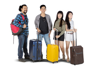 Young women and young men holding suitcase