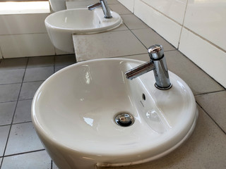 Hand washbasins at the public toilet. Installation complete with face mirror. Made from white glazed ceramic.
