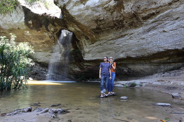 Women and men standing in Saeng Chan Waterfall at Pha Taem National Park, Ubon Ratchathani, Thailand