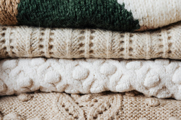 Folded winter sweaters close up