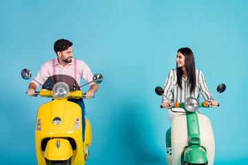 Positive cheerful lovely wife husband bikers drive choppers look enjoy motor bike way traveling wear striped pink formalwear shirt isolated over blue color background