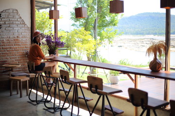 A woman watching the river view through the glass