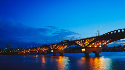 Fototapeta na wymiar Lighting up bridge over the river 
