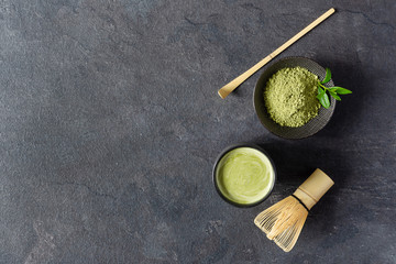 Organic green matcha tea. Matcha powder and matcha tea in a bowl. Chashaku spoon and chasen bamboo...