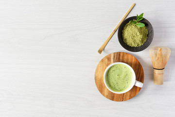 Organic green matcha tea. Matcha powder and matcha latte drink in a cup.
