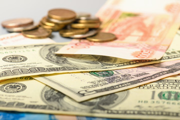 Cash banknotes and coins background. The background of the American and Russian money banknotes and coins. Dollars and rubles background.