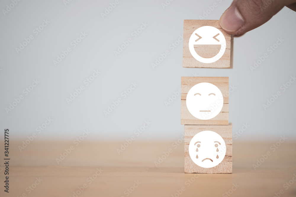 Aufkleber customer hand putting happy and smile face emotion which print screen on wooden block on sad emotion
