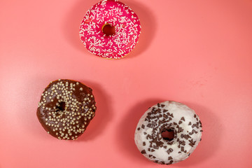Tasty donuts on pink background. Top view