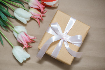 Fototapeta na wymiar Gift box and flowers. Romantic colorful present.