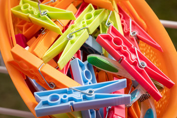 Colored clothespins for hanging cloths in a container